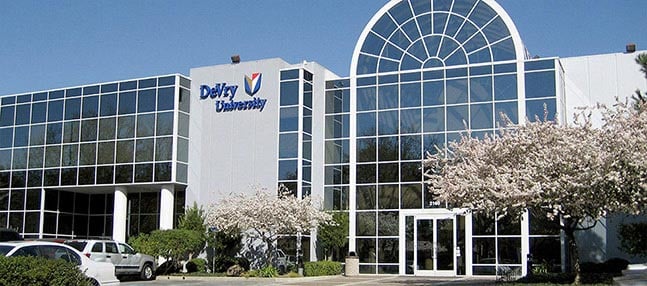 Modern campus building with glass facade, arched entrance, and "DeVry University" sign
