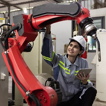 woman working on a robot arm