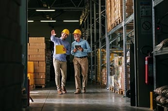 Two men in a warehouse