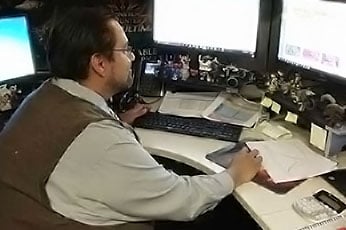 DeVry student, Marco Ruiz sitting at his work station