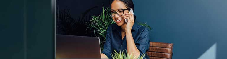 photo of woman on the phone at a computer