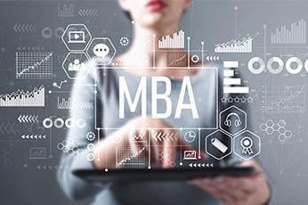 Professional holding tablet displaying "MBA" and business analytics overlays