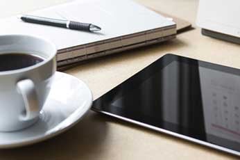tablet and coffee on desk