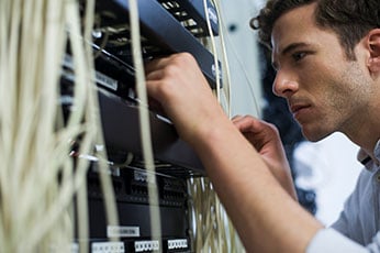 photo of man working on a computer circuit board