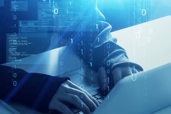 Hands typing on laptop with overlaid binary code and cybersecurity visuals
