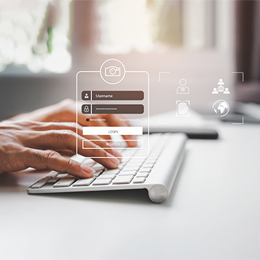 Hands typing on keyboard entering credentials into login form with "Username" and "LOGIN"