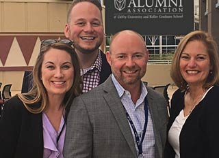 Four DeVry alumni smile while attending a DeVry Alumni Association event.