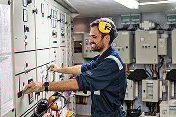 A technician applying engineering technology fundamentals while calibrating equipment in the field