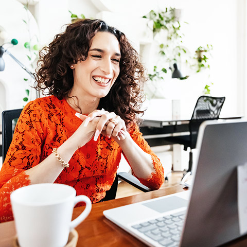 Woman sitting at a computer screen interviewing.