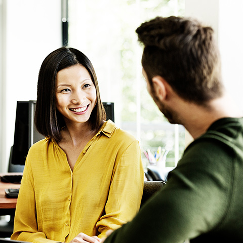 Woman sitting at a computer screen interviewing.