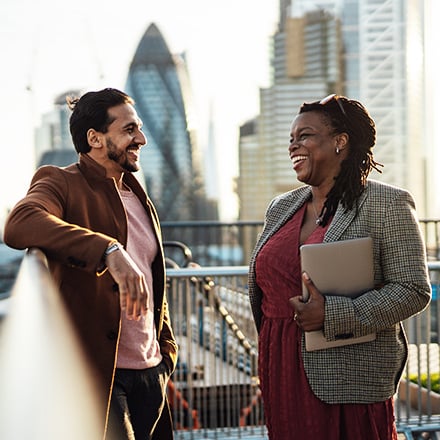 two people smiling outside