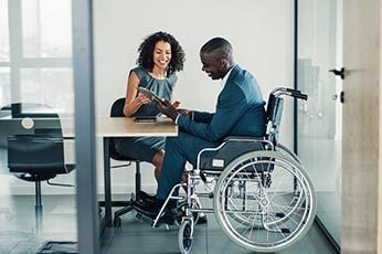 two coworkers working at a desk together