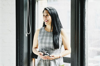 women smiling in front on window