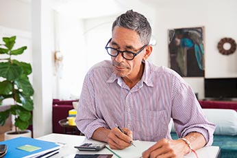 A Certified Public Accountant (CPA) auditing financial records, a responsibility that does not fall to general accountants.